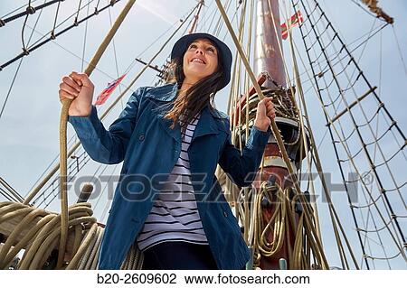 Young woman on the outside of a sailboat, galleon. Masts. Basque Country. Spain View Large Photo Image Stock Image - Young woman on the outside of a sailboat, galleon. Masts. Basque Country. Spain. Fotosearch