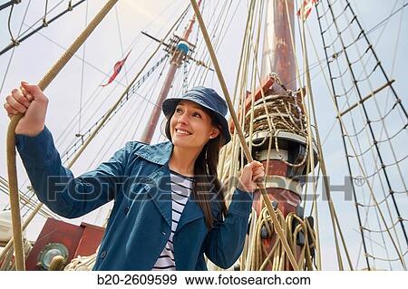 Young woman on the outside of a sailboat, galleon. Masts. Basque Country. Spain View Large Photo Image Stock Photo - Young woman on the outside of a sailboat, galleon. Masts. Basque Country. Spain. Fotosearch