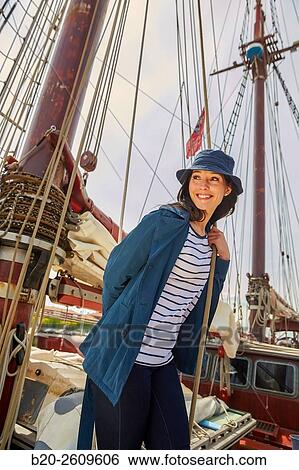 Stock Photograph - Young woman on the outside of a sailboat, galleon. Masts. Basque Country. Spain. Fotosearch