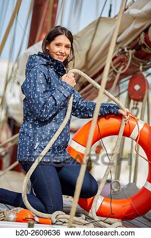 Young woman on the outside of a sailboat, galleon. Lifebuoy. Basque Country. Spain View Large Photo Image Stock Photograph - Young woman on the outside of a sailboat, galleon. Lifebuoy. Basque Country. Spain. Fotosearch