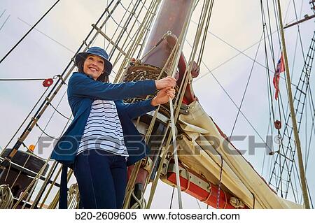 Young woman on the outside of a sailboat, galleon. Masts. Basque Country. Spain View Large Photo Image Stock Photography - Young woman on the outside of a sailboat, galleon. Masts. Basque Country. Spain. Fotosearch