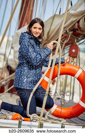 Young woman on the outside of a sailboat, galleon. Lifebuoy. Basque Country. Spain View Large Photo Image Stock Photography - Young woman on the outside of a sailboat, galleon. Lifebuoy. Basque Country. Spain. Fotosearch