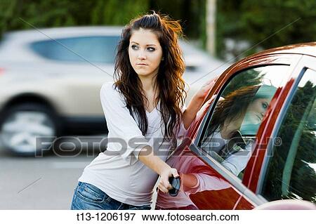 Stock Photo - Young woman on the parking place. Fotosearch