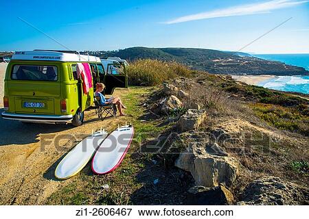 young woman sit and read next to camper with surfboards with view at the coast of Portugal View Large Photo Image Stock Photo - young woman sit and read next to camper with surfboards with view at the coast of Portugal. Fotosearch