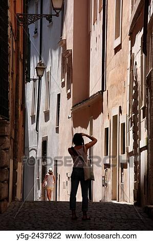 young woman tourist taking photograph in street road in the Santa Angelo district near the Jewish ghetto in Rome, Italy. View Large Photo Image Stock Image - young woman tourist taking photograph in street road in the Santa Angelo district near the Jewish ghetto in Rome, Italy.. Fotosearch