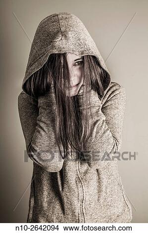 Picture - Young woman wearing a sweatshirt and hoodie.. Fotosearch
