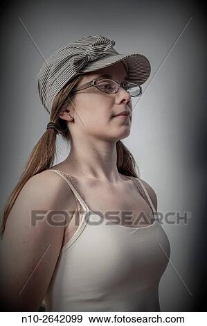 Young woman wearing glasses and a hat. View Large Photo Image Stock Photo - Young woman wearing glasses and a hat.. Fotosearch
