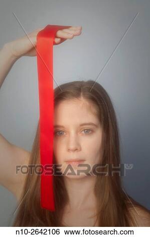 Young woman with a red ribbon. View Large Photo Image Stock Photograph - Young woman with a red ribbon.. Fotosearch