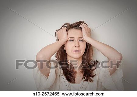 Young woman with her hands on her head. View Large Photo Image Stock Photography - Young woman with her hands on her head.. Fotosearch