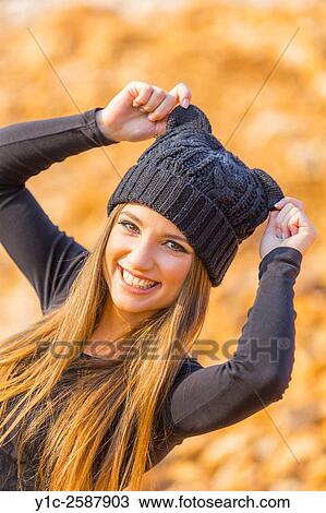 Stock Image - Young woman with wool cap happy. Fotosearch