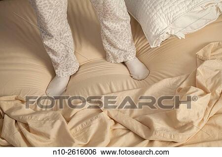 Young womans feet standing on her bed. View Large Photo Image Stock Photograph - Young womans feet standing on her bed.. Fotosearch
