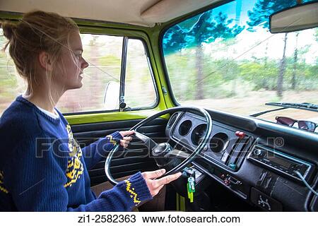 Stock Image - youngster drives vw camping bus. Fotosearch