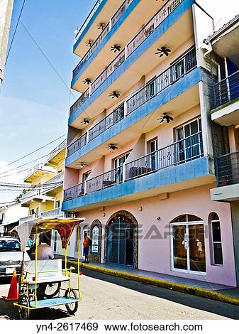 Stock Photo - A bicycle taxi at the curb in San Juan del Sur, Nicaragua.. Fotosearch