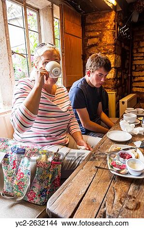 A family enjoy a cream tea at the Plough Inn,. Ford,. Temple Guiting,. Cheltenham, England, Britain, Uk. View Large Photo Image Picture - A family enjoy a cream tea at the Plough Inn,. Ford,. Temple Guiting,. Cheltenham, England, Britain, Uk.. Fotosearch