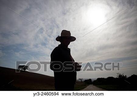 Picture - A goatherd look at his goat herd in Prado del Rey, Sierra de Cadiz, Andalusia, Spain.. Fotosearch