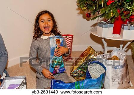 A Mixed Race Child Opening Her Christmas Presents On Christmas Day, Brighton, Sussex, UK. View Large Photo Image Stock Image - A Mixed Race Child Opening Her Christmas Presents On Christmas Day, Brighton, Sussex, UK.. Fotosearch