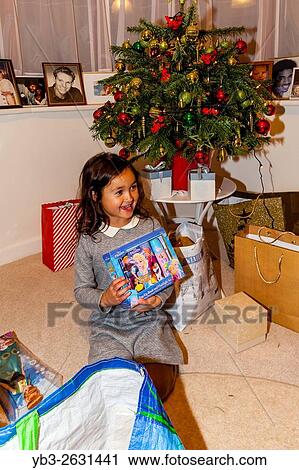 A Mixed Race Child Opening Her Christmas Presents On Christmas Day, Brighton, Sussex, UK. View Large Photo Image Stock Image - A Mixed Race Child Opening Her Christmas Presents On Christmas Day, Brighton, Sussex, UK.. Fotosearch