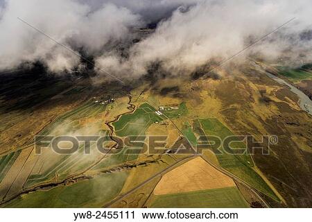 Aerial view of cloud covered river and farmland, Iceland. View Large Photo Image Stock Image - Aerial view of cloud covered river and farmland, Iceland.. Fotosearch