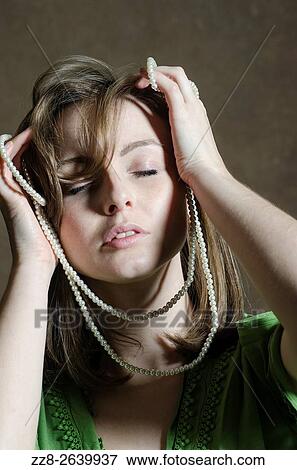 Anxious young woman with pearl necklace. View Large Photo Image Stock Photo - Anxious young woman with pearl necklace.. Fotosearch