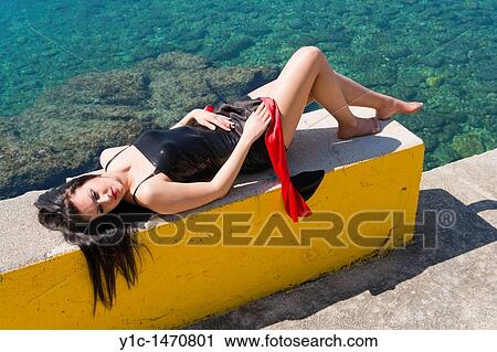 Attractive young woman is enjoying sun before the Summer View Large Photo Image Stock Image - Attractive young woman is enjoying sun before the Summer. Fotosearch