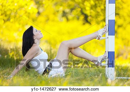 Stock Photo - Attractive young woman is posing on a goal line. Fotosearch