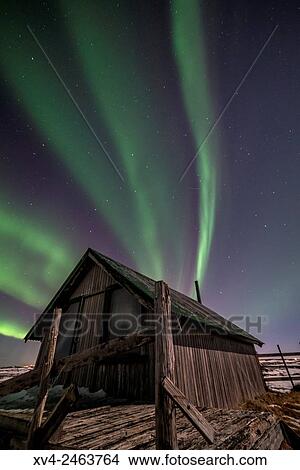 Aurora borealis above wooden house by Night, Iceland. View Large Photo Image Picture - Aurora borealis above wooden house by Night, Iceland.. Fotosearch