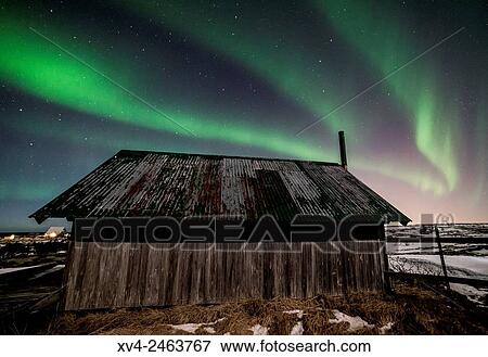Aurora borealis above wooden house by Night, Iceland. View Large Photo Image Stock Photo - Aurora borealis above wooden house by Night, Iceland.. Fotosearch