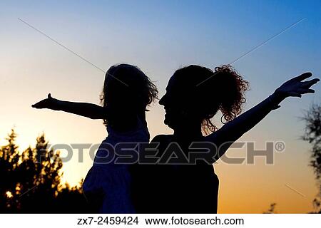 Backlighting. Mother with a child. Sunset. Pudent Lake. Formentera. Balearic Islands, Spain, Europe. View Large Photo Image Picture - Backlighting. Mother with a child. Sunset. Pudent Lake. Formentera. Balearic Islands, Spain, Europe.. Fotosearch