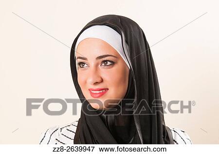 Beautiful young Middle Eastern Muslim woman looking up smiling. View Large Photo Image Stock Photo - Beautiful young Middle Eastern Muslim woman looking up smiling.. Fotosearch