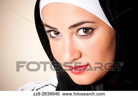 Stock Photograph - Beautiful young Middle Eastern Muslim woman.. Fotosearch