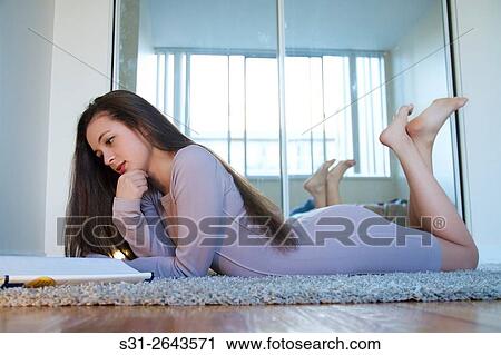 Stock Image - beautiful young Russian girl studying on floor.. Fotosearch