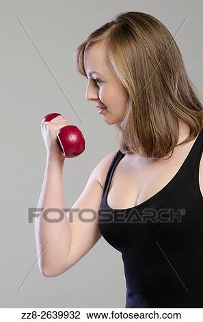 Beautiful young woman working out with dubbells. View Large Photo Image Stock Image - Beautiful young woman working out with dubbells.. Fotosearch