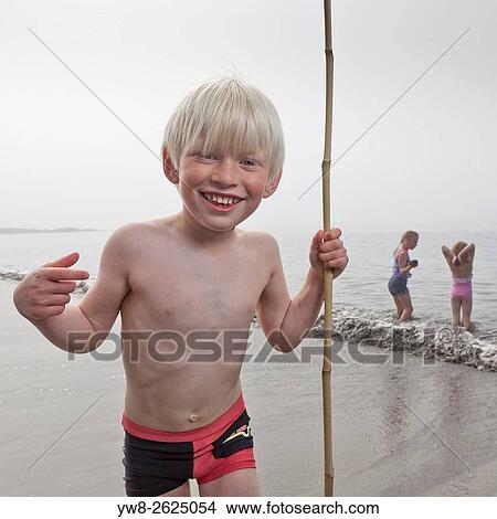 Boy wih net playing at the beach, Akranes, Iceland. View Large Photo Image Picture - Boy wih net playing at the beach, Akranes, Iceland.. Fotosearch