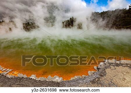 Champagne pool, burst of sunshine lights up foreshore during day of blowing mist and heavy rain, Wai-o-Tapu thermal region, Rotorua. View Large Photo Image Stock Photo - Champagne pool, burst of sunshine lights up foreshore during day of blowing mist and heavy rain, Wai-o-Tapu thermal region, Rotorua.. Fotosearch