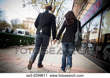 Stock Image - Couple walking in street. Fotosearch