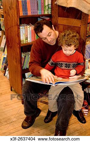 Dad reading to son in nook of bookstore age 42 and 3. Wild Rumpus Childrens Bookstore Minneapolis Minnesota USA. View Large Photo Image Picture - Dad reading to son in nook of bookstore age 42 and 3. Wild Rumpus Childrens Bookstore Minneapolis Minnesota USA.. Fotosearch