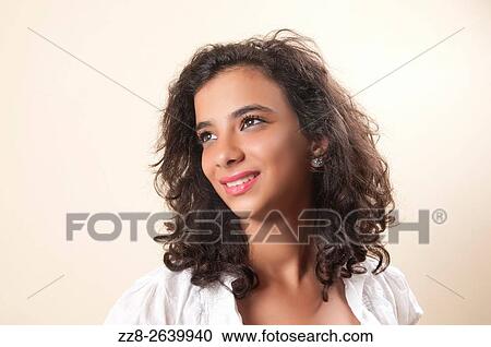 Daydreaming teenage girl looking up smiling. View Large Photo Image Stock Image - Daydreaming teenage girl looking up smiling.. Fotosearch