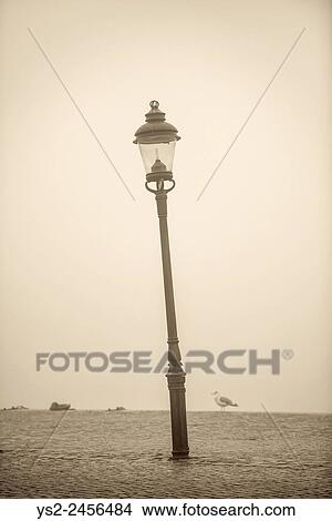 Empty waterfront in heavy fog. Tranquil city scene with old lamppost in Stockholm, Sweden. View Large Photo Image Picture - Empty waterfront in heavy fog. Tranquil city scene with old lamppost in Stockholm, Sweden.. Fotosearch