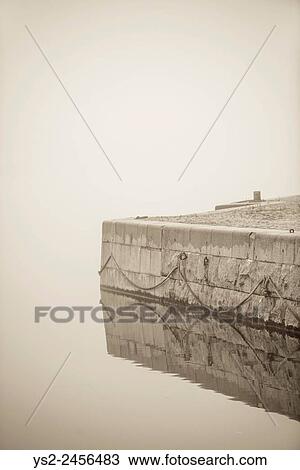 Empty waterfront in heavy fog. Tranquil city scene in Stockholm, Sweden. View Large Photo Image Stock Image - Empty waterfront in heavy fog. Tranquil city scene in Stockholm, Sweden.. Fotosearch