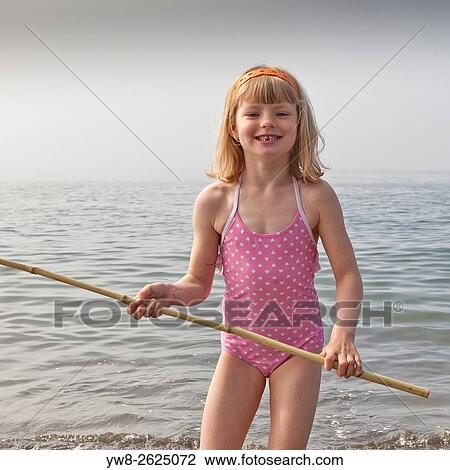 Girl wih fishing net playing at the beach, Akranes, Iceland. View Large Photo Image Stock Image - Girl wih fishing net playing at the beach, Akranes, Iceland.. Fotosearch