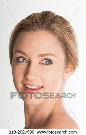 Stock Image - Happy young woman looking away smiling.. Fotosearch