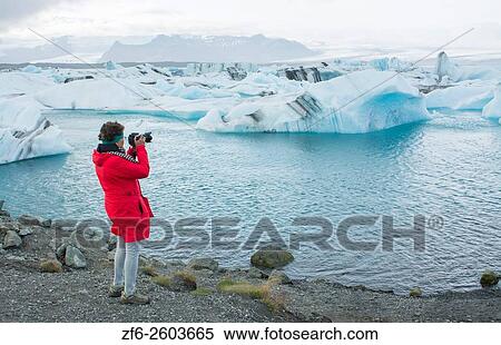 Iceland Jokulsarlon glaciers and icebergs on lake lagoon with photographers on edge of Vatnajokull National Park in Southeast Iceland Model Releasaed MR-1. View Large Photo Image Stock Photography - Iceland Jokulsarlon glaciers and icebergs on lake lagoon with photographers on edge of Vatnajokull National Park in Southeast Iceland Model Releasaed MR-1.. Fotosearch