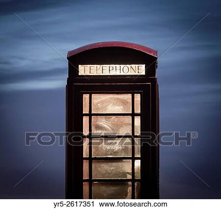Man making call from red telephone box at night. England, United Kingdom. View Large Photo Image Stock Image - Man making call from red telephone box at night. England, United Kingdom.. Fotosearch