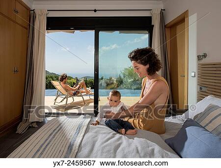 Stock Photo - Mother, baby and father at home.. Fotosearch