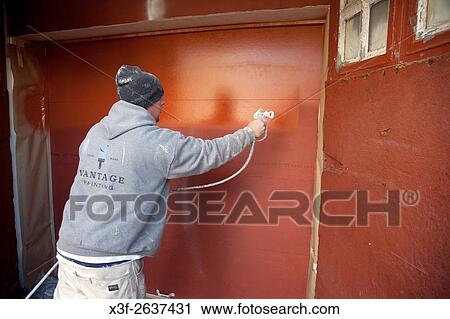 Painter power spraying garage door with paint. St Paul Minnesota MN USA. View Large Photo Image Stock Image - Painter power spraying garage door with paint. St Paul Minnesota MN USA.. Fotosearch