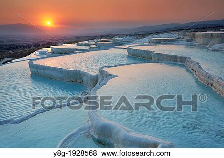 Stock Photo - Pamukkale, the limestone terraces, view at sunset time, Pamukkale near Denizli, Turkey. Fotosearch