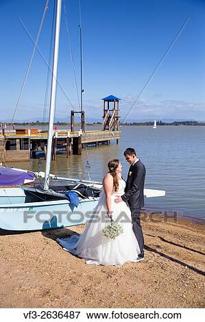 Portrait of a bride and groom on their wedding day at a yacht club marina in Oregon. View Large Photo Image Stock Photo - Portrait of a bride and groom on their wedding day at a yacht club marina in Oregon.. Fotosearch