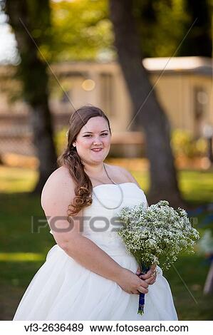 Portrait of a bride in her wedding dress outdoors in Oregon at a yacht club marina. View Large Photo Image Stock Photo - Portrait of a bride in her wedding dress outdoors in Oregon at a yacht club marina.. Fotosearch