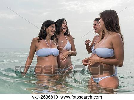 Stock Image - Pregnant women at the beach. Tarifa, Costa de la Luz, Cadiz, Andalusia, Southern Spain, Europe.. Fotosearch