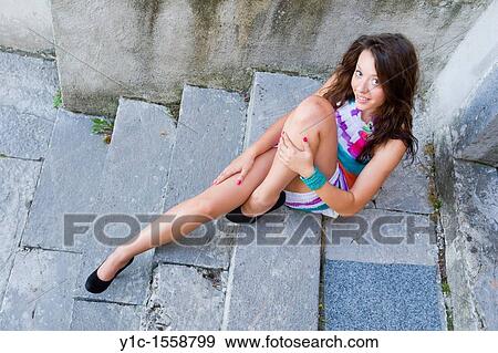 Stock Photo - Pretty young woman in colorful sundress. Fotosearch